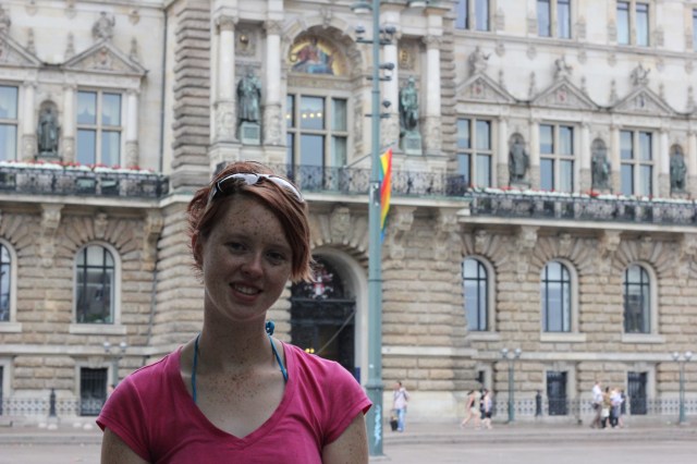 Me standing in front of Das Verdammte Rathaus. Note the pride flag they hung above the entrance!