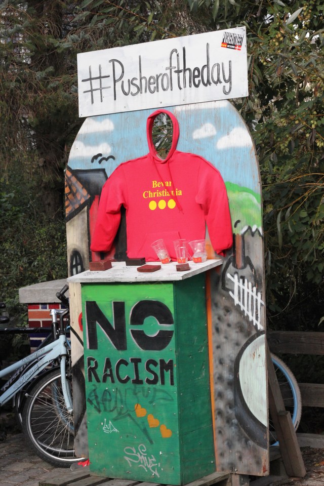They even had a photo-op where you could pose as a drug dealer. I'm not sure why anyone would want to do this. The three yellow circles on a red background are the flag of Christiania.