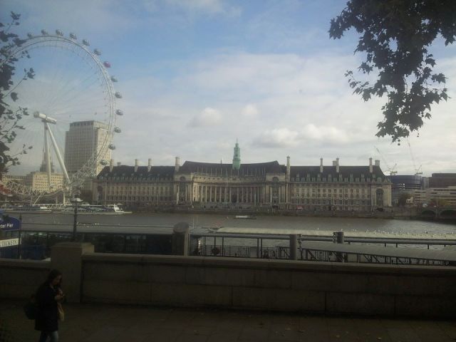 London county house and London Eye, as seen from a bus window.