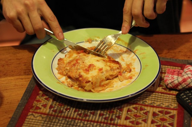 This is how civilized Europeans hold their knife and fork. Americans usually eat with a fork in their right hand, left hand in their lap. I'm such a savage!