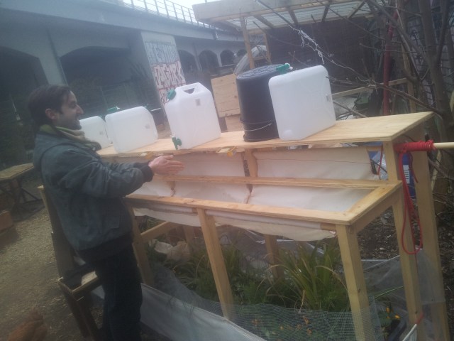 The jugs are full of water that's been collected in the rain barrels. After you wash your hands, the soapy water filters through a fine cloth and drips onto the plants below.